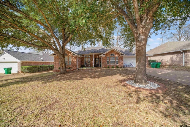 ranch-style home featuring an attached garage and a front lawn