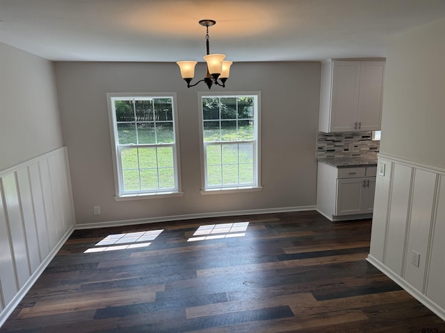 2533 Chelsea Dr, Tyler, TX 75701 - unfurnished dining area featuring a chandelier and dark wood-style floors