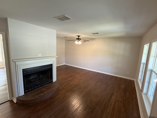 2533 Chelsea Dr, Tyler, TX 75701 - unfurnished living room featuring dark wood finished floors, a ceiling fan, and a fireplace