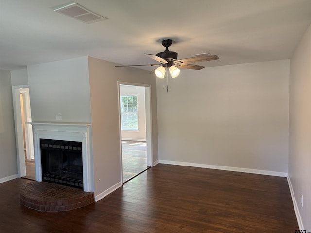 2533 Chelsea Dr, Tyler, TX 75701 - unfurnished living room with wood finished floors, ceiling fan, and a brick fireplace