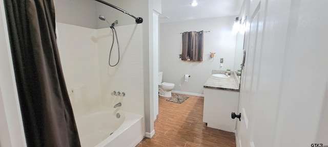 full bathroom featuring wood-type flooring, toilet, shower / bathing tub combination, and vanity