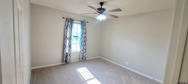 carpeted empty room featuring ceiling fan and plenty of natural light