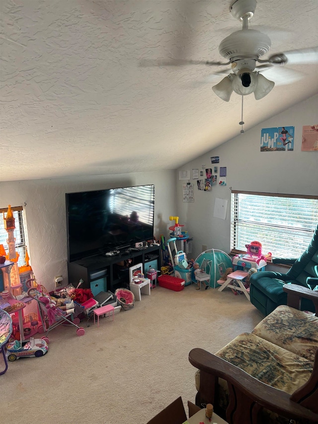 carpeted living room featuring a textured ceiling, ceiling fan, and vaulted ceiling