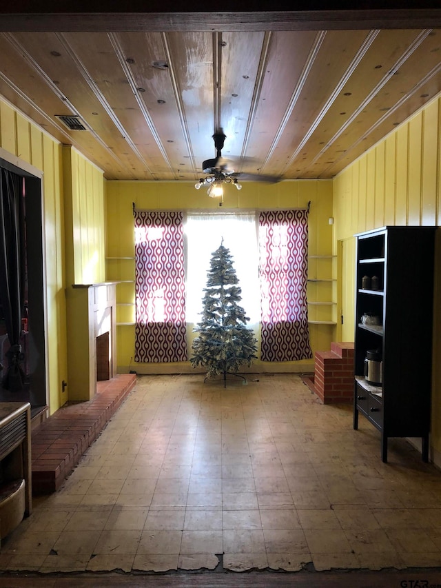 interior space with ceiling fan