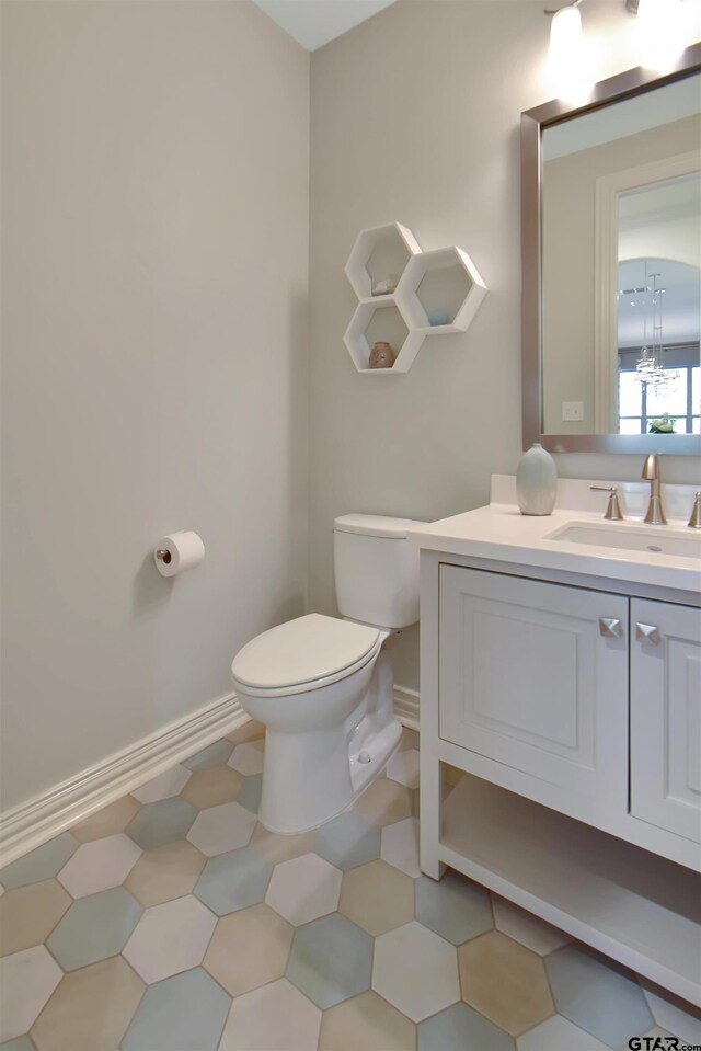 bathroom with tile patterned floors, vanity, and toilet