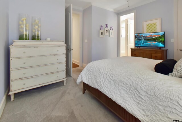 carpeted bedroom featuring crown molding