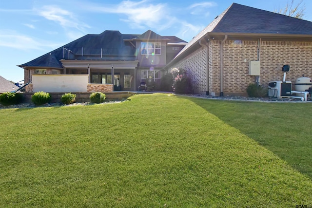 rear view of house featuring a lawn