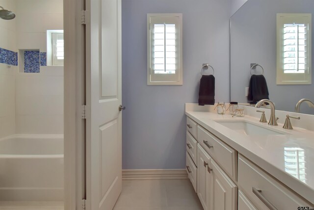 bathroom featuring tile patterned floors, a wealth of natural light, and vanity