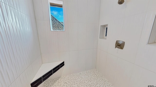 bathroom with a tile shower