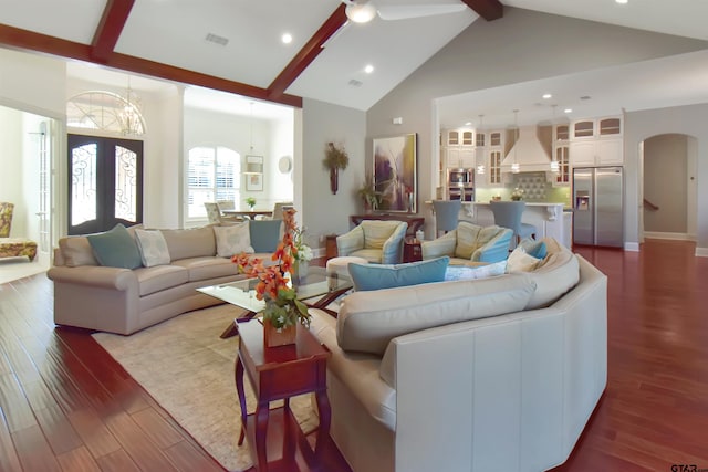 living room featuring hardwood / wood-style flooring, ceiling fan, beamed ceiling, and high vaulted ceiling