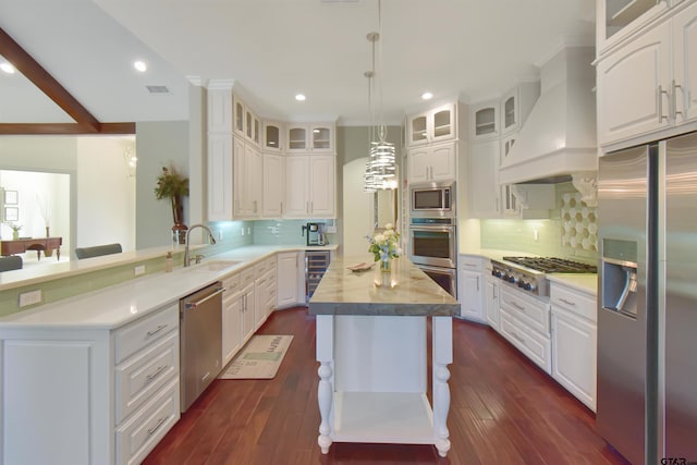 kitchen with dark hardwood / wood-style floors, white cabinetry, hanging light fixtures, and appliances with stainless steel finishes