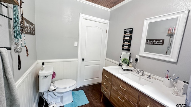 bathroom with ornamental molding, hardwood / wood-style floors, vanity, and toilet