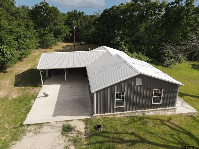 exterior space featuring a yard and a carport