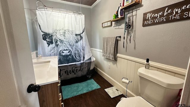 bathroom featuring hardwood / wood-style flooring, walk in shower, ornamental molding, vanity, and toilet