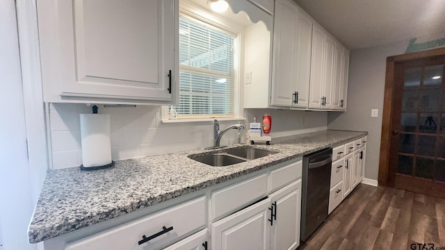 kitchen featuring white cabinetry, sink, light stone counters, dishwasher, and dark hardwood / wood-style flooring