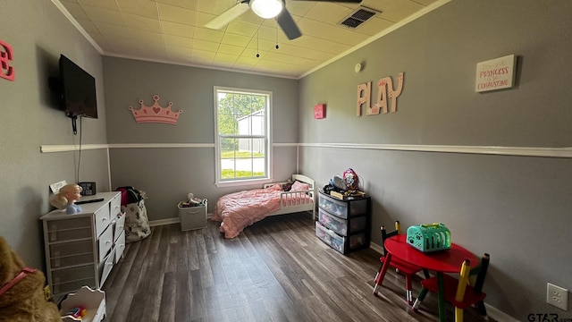 bedroom featuring ceiling fan, dark hardwood / wood-style floors, and ornamental molding