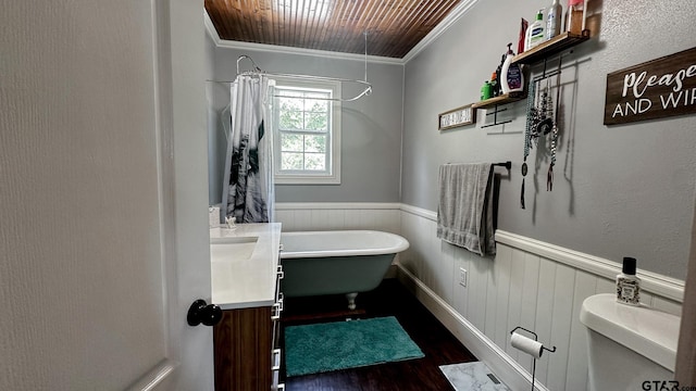 bathroom with toilet, hardwood / wood-style flooring, ornamental molding, a bathtub, and vanity