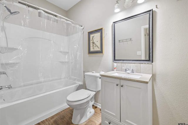 18313 Highmeadow Cir, Flint, TX 75762 - bathroom featuring toilet, shower / bath combo with shower curtain, a textured wall, vanity, and wood finished floors