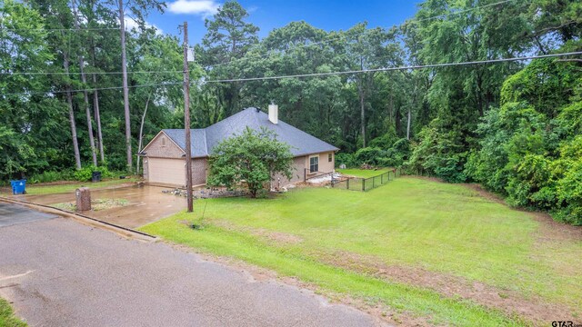 18313 Highmeadow Cir, Flint, TX 75762 - view of front of house featuring a chimney, a garage, and a forest view