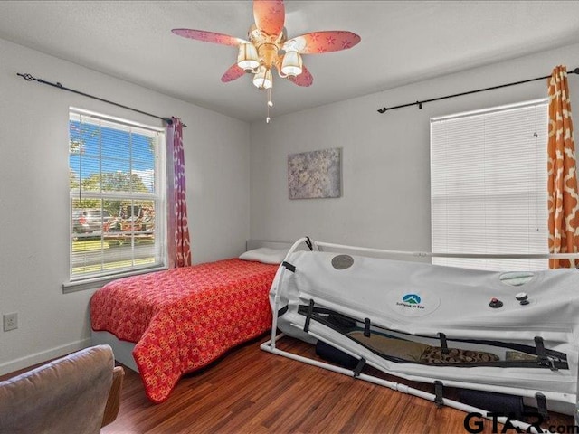 bedroom with hardwood / wood-style flooring and ceiling fan