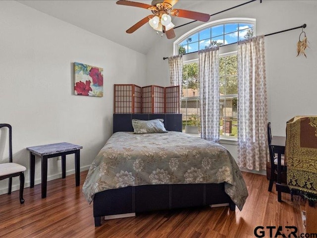 bedroom with wood-type flooring, ceiling fan, and vaulted ceiling