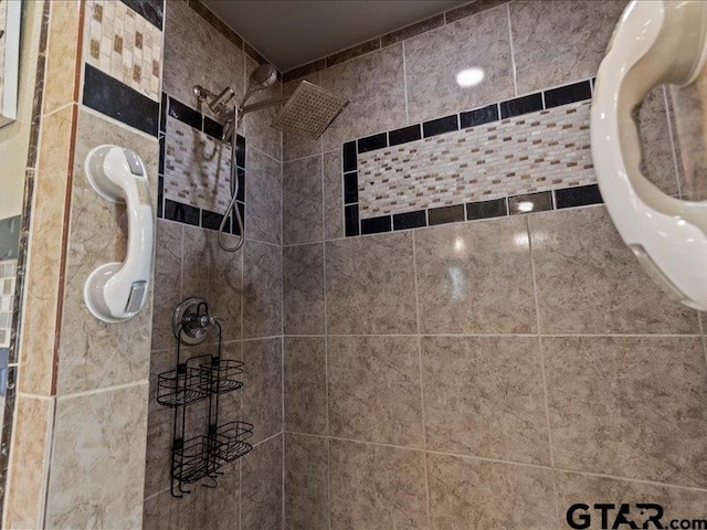 bathroom with tile walls and a tile shower