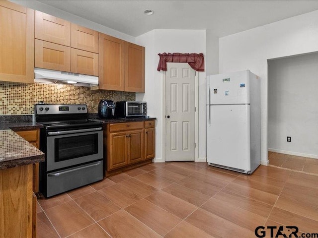 kitchen featuring light tile patterned floors, stainless steel electric range oven, backsplash, and white fridge