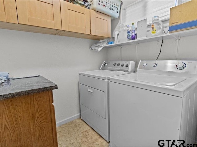 washroom featuring cabinets and independent washer and dryer