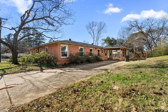 2444 Sunnybrook Dr, Tyler, TX 75701 - rear view of property featuring a carport and a lawn