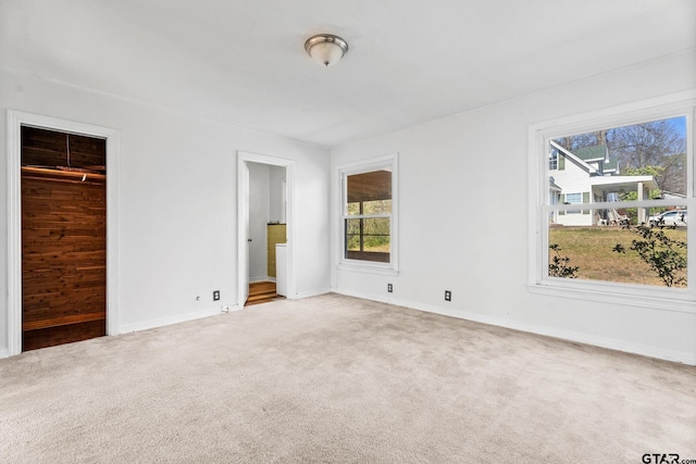 2444 Sunnybrook Dr, Tyler, TX 75701 - unfurnished bedroom with multiple windows, ensuite bath, and carpet flooring