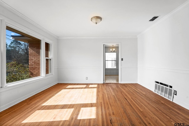 2444 Sunnybrook Dr, Tyler, TX 75701 - unfurnished room with hardwood / wood-style flooring, crown molding, an inviting chandelier, and heating unit