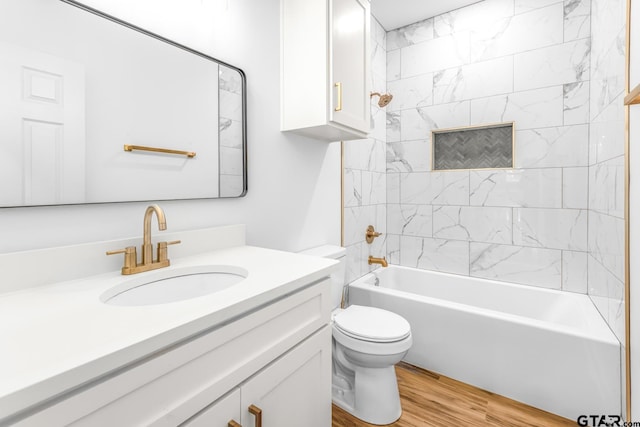 bathroom with toilet, vanity, shower / bath combination, and wood finished floors