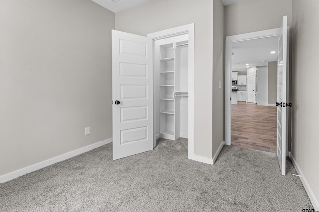 unfurnished bedroom with a closet and light carpet