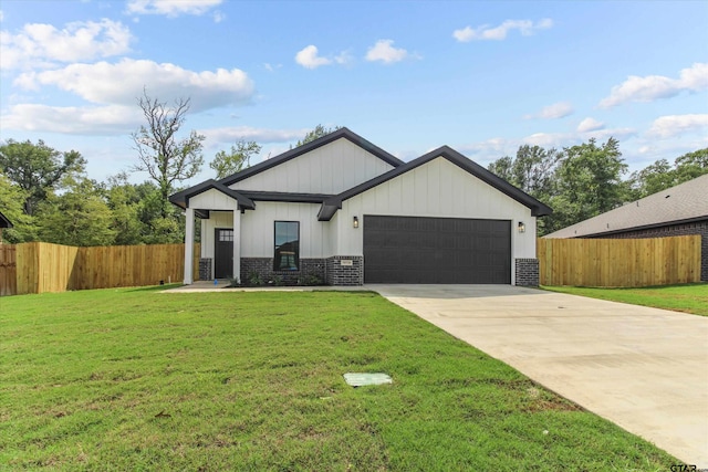 view of front of house with a garage and a front yard