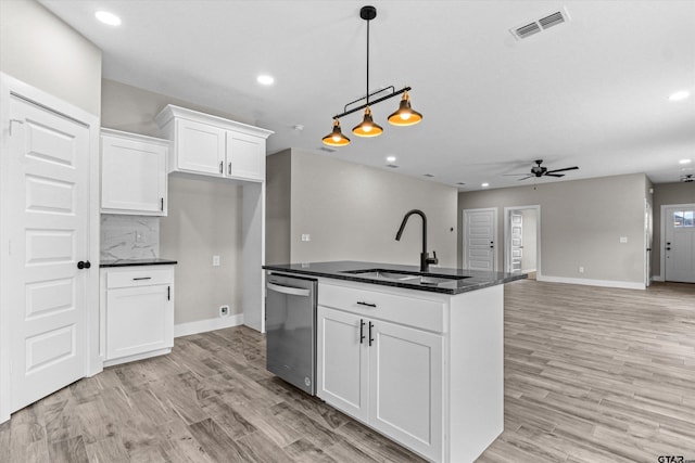 kitchen with a center island with sink, sink, white cabinets, stainless steel dishwasher, and light hardwood / wood-style flooring