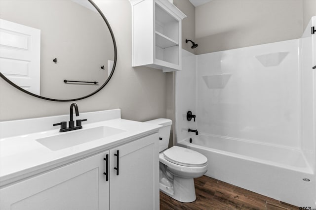 full bathroom with  shower combination, wood-type flooring, vanity, and toilet