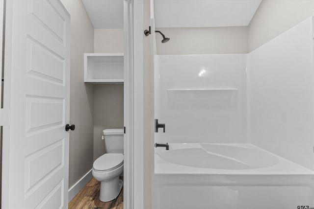 bathroom with toilet, wood-type flooring, and bathing tub / shower combination