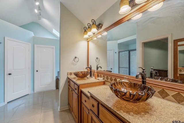 3072 Yasmeen Cir, Flint, TX 75762 - full bath with tile patterned floors, a shower with shower door, vaulted ceiling, vanity, and baseboards