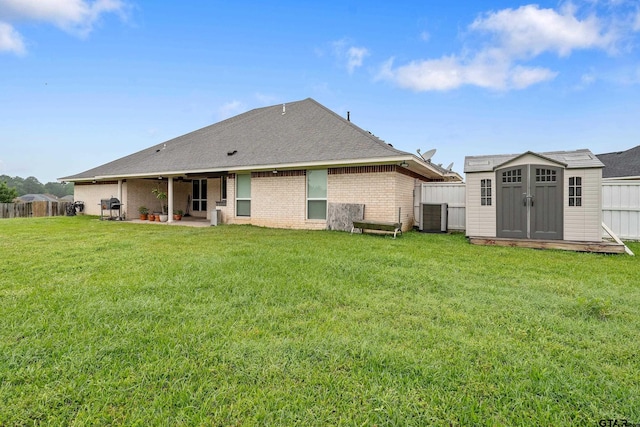 3072 Yasmeen Cir, Flint, TX 75762 - back of house with a shed, a patio, brick siding, central AC, and an outbuilding