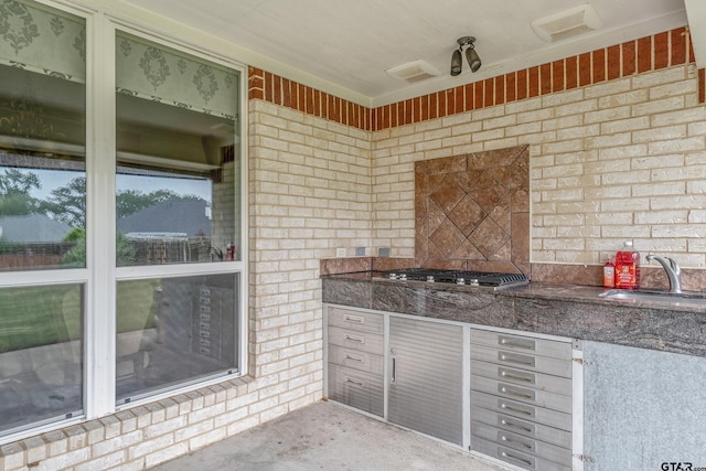 3072 Yasmeen Cir, Flint, TX 75762 - kitchen featuring a sink, stainless steel gas stovetop, dark stone counters, and concrete floors