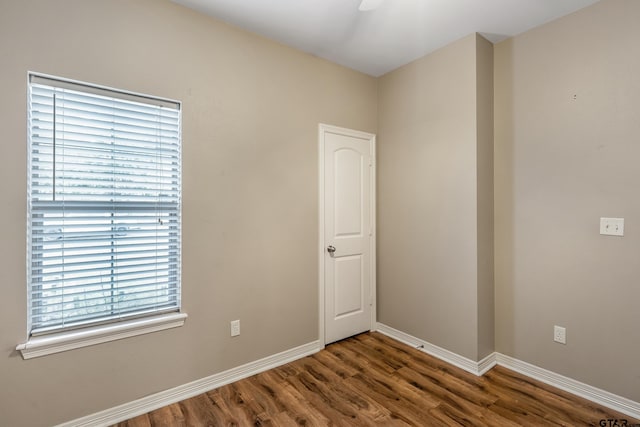 spare room with dark hardwood / wood-style floors