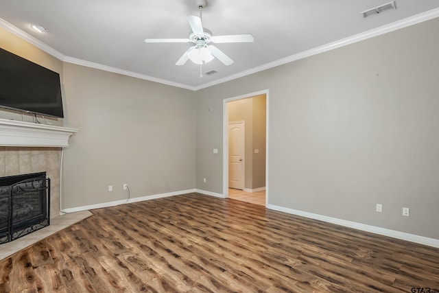 unfurnished living room featuring a tile fireplace, hardwood / wood-style flooring, ceiling fan, and crown molding