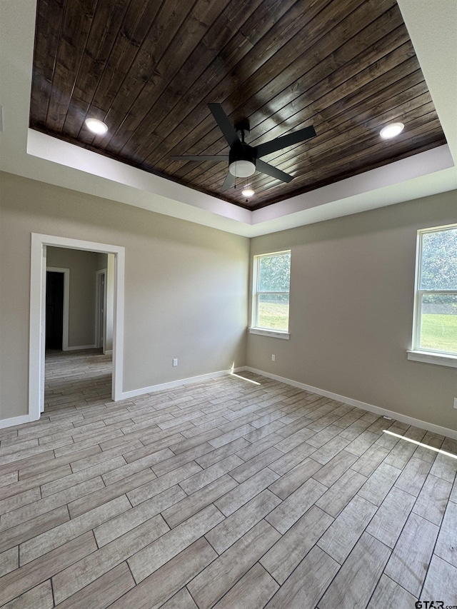 18268 US Jones Dr, Tyler, TX 75705 - unfurnished room with wood ceiling, a raised ceiling, wood finished floors, and a ceiling fan