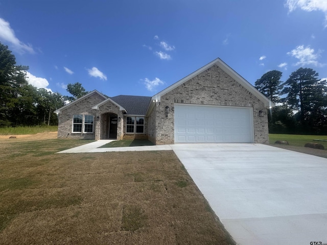18268 US Jones Dr, Tyler, TX 75705 - ranch-style house with brick siding, a garage, driveway, and a front yard