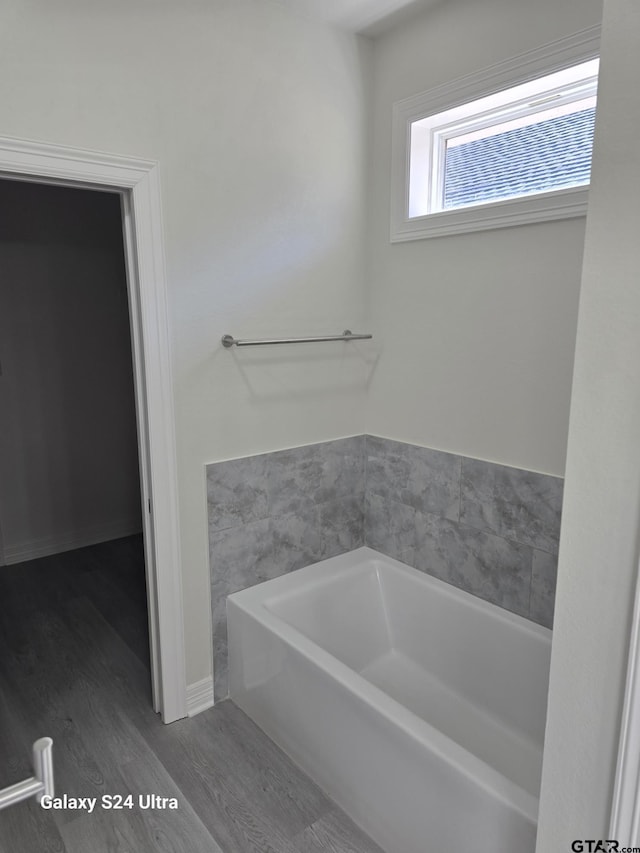 bathroom featuring a bath and hardwood / wood-style floors