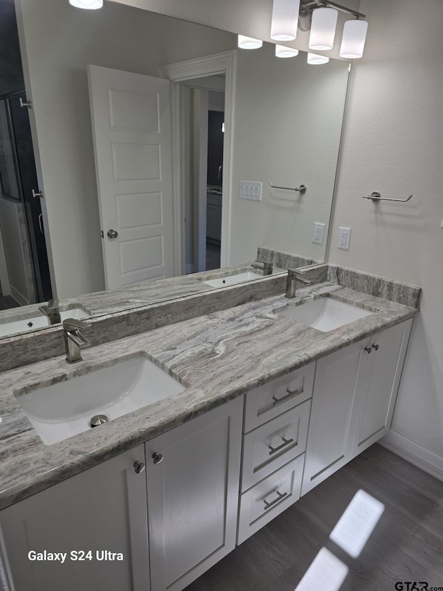 bathroom featuring vanity and hardwood / wood-style floors