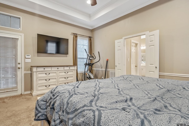 bedroom with ceiling fan, ornamental molding, a raised ceiling, and light carpet