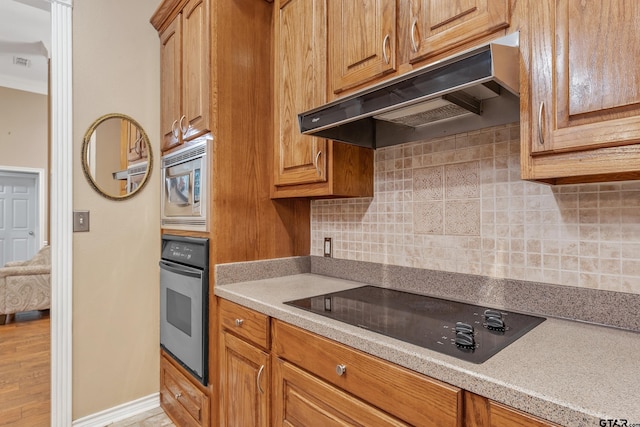 kitchen with tasteful backsplash and stainless steel appliances