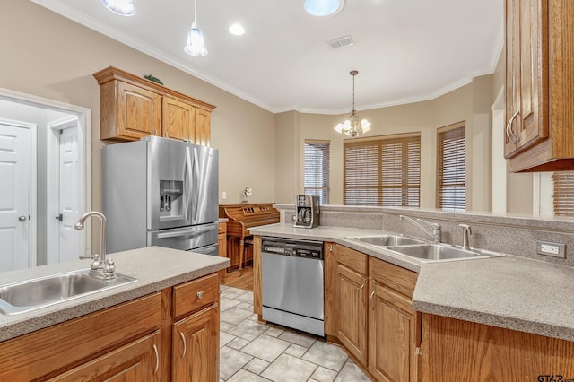 kitchen featuring pendant lighting, ornamental molding, stainless steel appliances, and sink