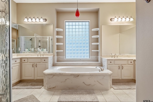 bathroom featuring vanity, plenty of natural light, tile patterned floors, and separate shower and tub